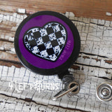 Purple background checkered heart badge reel clip.