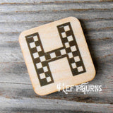 Checkered letter H wooden magnet.