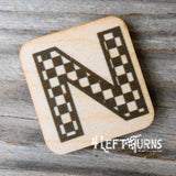 Checkered letter N wooden magnet.