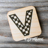 Checkered letter V wooden magnet.