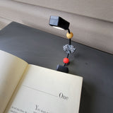 Book light clipped to book.