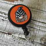 Gnome with orange background badge reel clip.