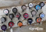 Group of various racing themed badge reel clips.