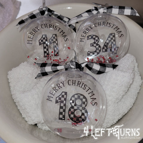 Clear floating Christmas ornaments with checkered race car numbers.