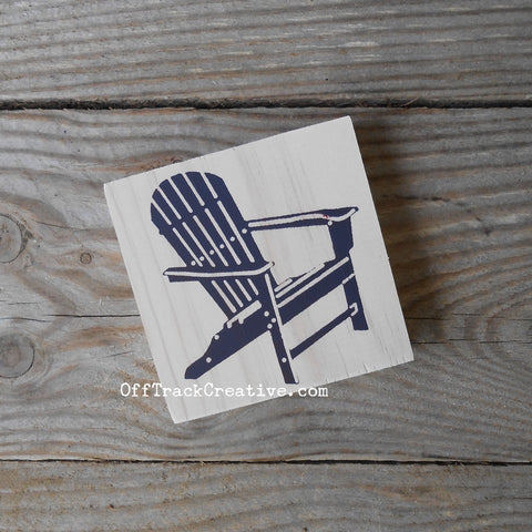 Small sign featuring a navy blue Adirondack chair.
