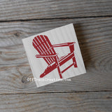 Small sign featuring a red Adirondack chair.