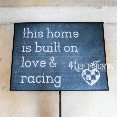 This home is built on love and racing welcome mat.