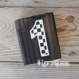 Block of wood with painted on checkered number 1.