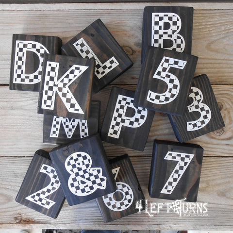 Blocks of wood with checkered letters painted on.