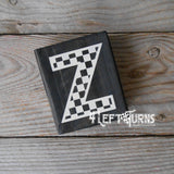 Block of wood with painted on checkered letter Z.