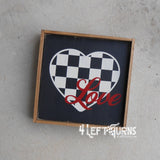 Wood sign with checkered heart and the word Love in red.