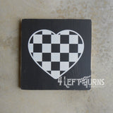 Checkered heart on painted wood sign.