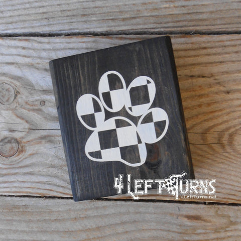 Wood block with black and white checkered paw print.