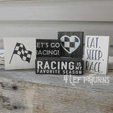 Tiny wooden racing themed signs.