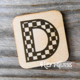 Checkered letter D wooden magnet.