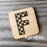 Checkered letter F wooden magnet.