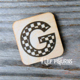 Checkered letter G wooden magnet.