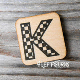 Checkered letter K wooden magnet.