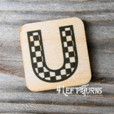 Checkered letter U wooden magnet.