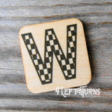 Checkered letter W wooden magnet.